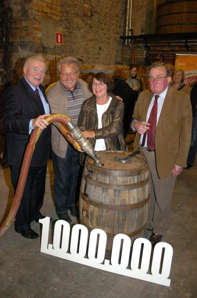 kilbeggan-5 Mr. Erwin Hennefarth and his wife fill their very own cask of Kilbeggan Malt, as they are celebrated as the 1 Millionth Visitor to Kilbeggan Distillery, along with the chairman John Teeling (left) and the Distillery Manager Brian Quinn (right)