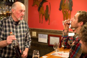 Bob Townsend waits with anticipation as Daren Opeka samples one of the fine Scotches on offer. (Brad Christensen)