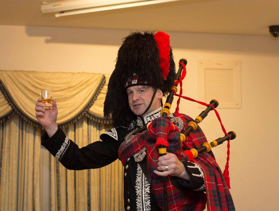 Spud the Piper with a whisky toast